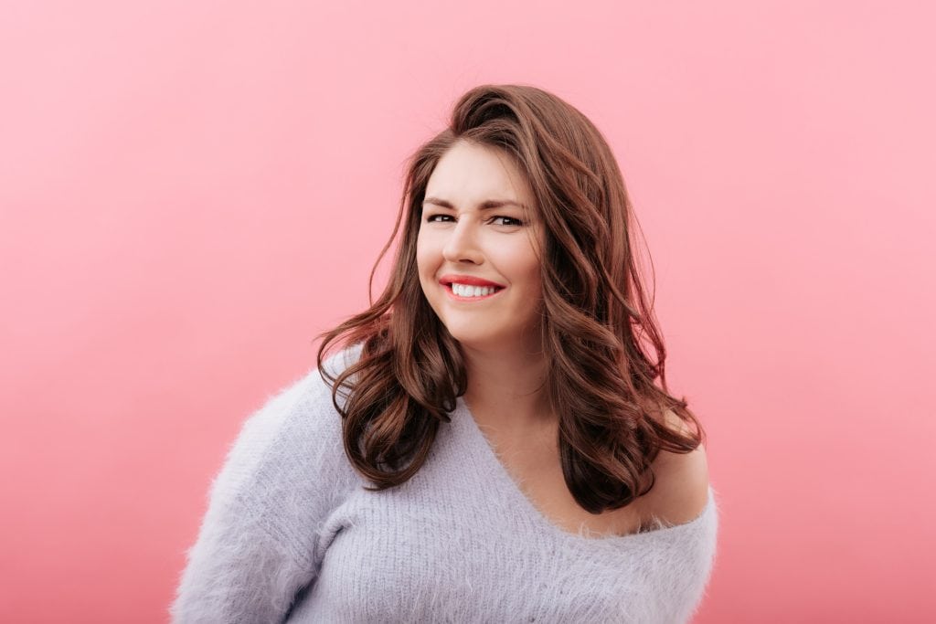 Plus size vrouw bijt op lip tijdens dirty talk